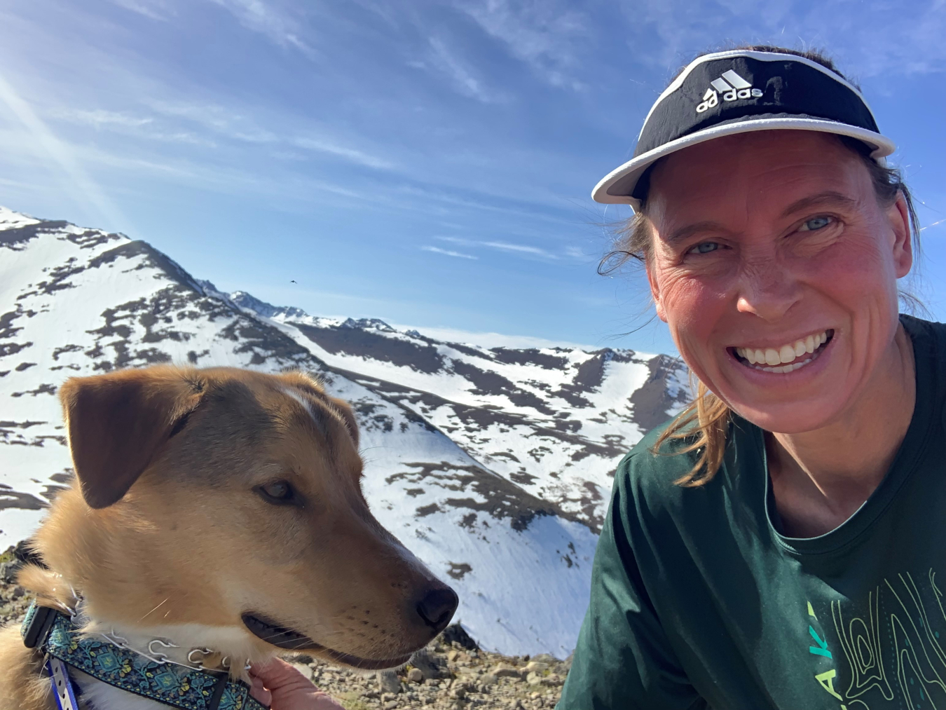 Dr. Erin Whitney and her dog, Barry, with the mountains behind them. 