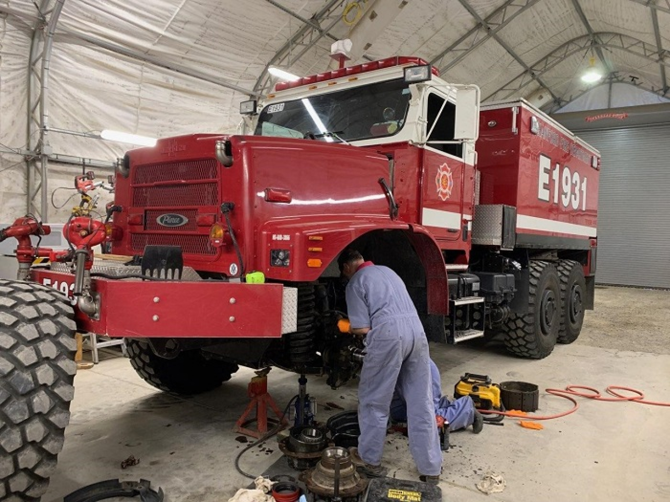 Hanford Mission Integration Solutions mechanics Mark Moore, left, and Kevin Claybrook repair a Hanford Fire Department brush truck in preparation for the 2023 fire season.