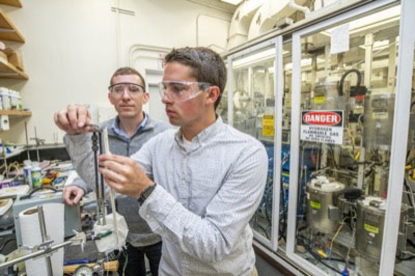 Ian Robinson working in a lab as his mentor watches