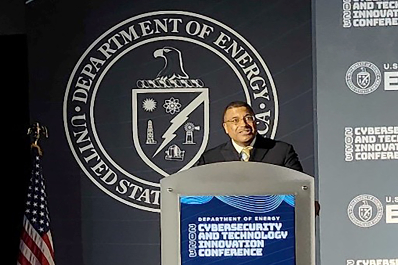 Frank Rose gives a speech from behind a dais that says Department of Energy Cybersecurity and Technology Innovation Conference.