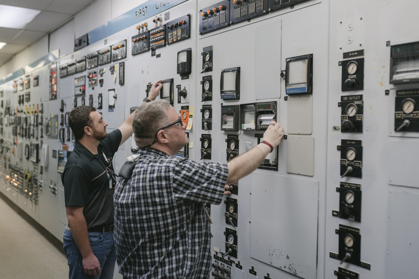 H Canyon Control Room operators Tyler Sullivan and Paul Gettle check First Uranium Cycle readings during its recent inactivation activities.