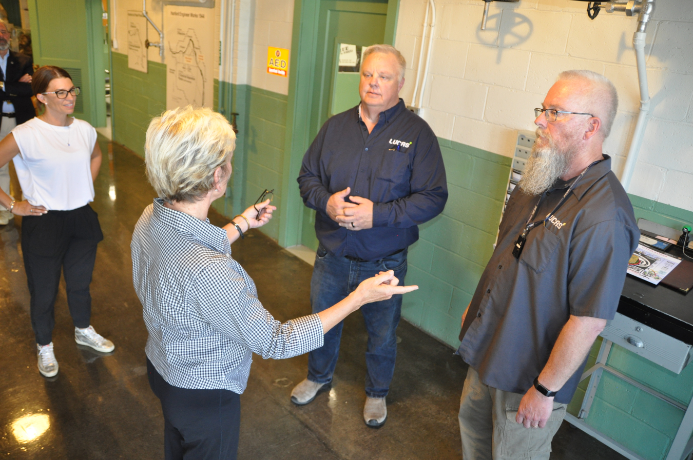 Chris, center, and John Lucas, right, of Lucas Engineering and Management Services, talked with Energy Secretary Jennifer Granholm, second from left, during a guided tour of the Hanford Site’s historic B Reactor in August 2022. 