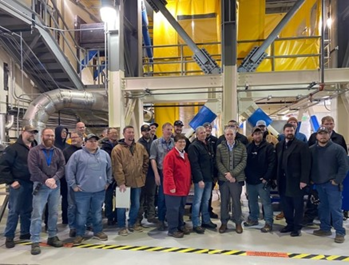 EM Senior Advisor William "Ike" White and Idaho Cleanup Project Manager Connie Flohr, at center, thank Integrated Waste Treatment Unit staff at the Idaho National Laboratory Site in late March as they prepared for the start of radiological operations.