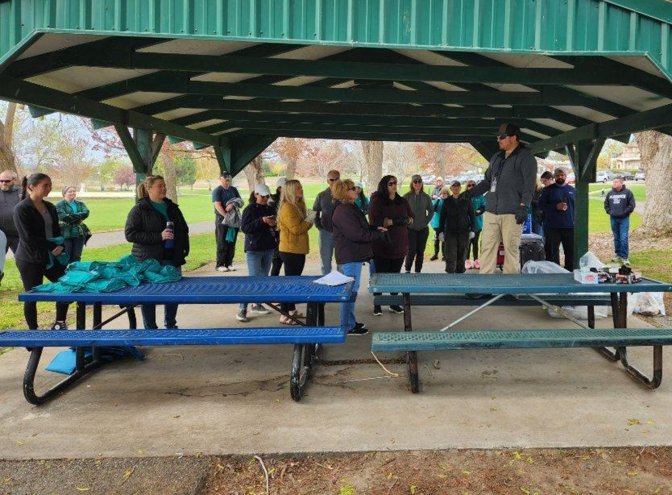 A park ranger with the city of Richland Parks and Recreation Department shared instructions before Hanford Site volunteers fanned out to pick up litter during a One Hanford Earth Day cleanup event at a community park.