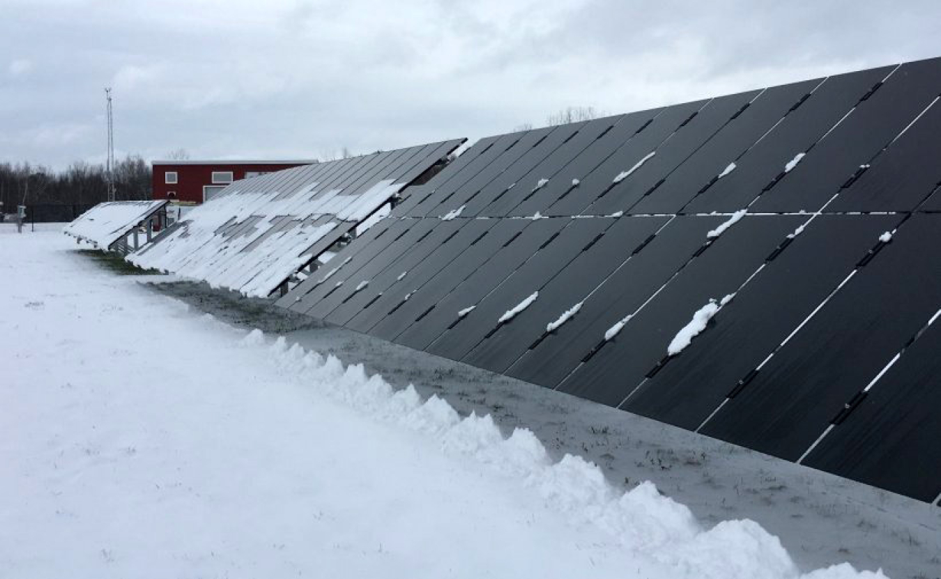 Solar panels partially covered with snow.