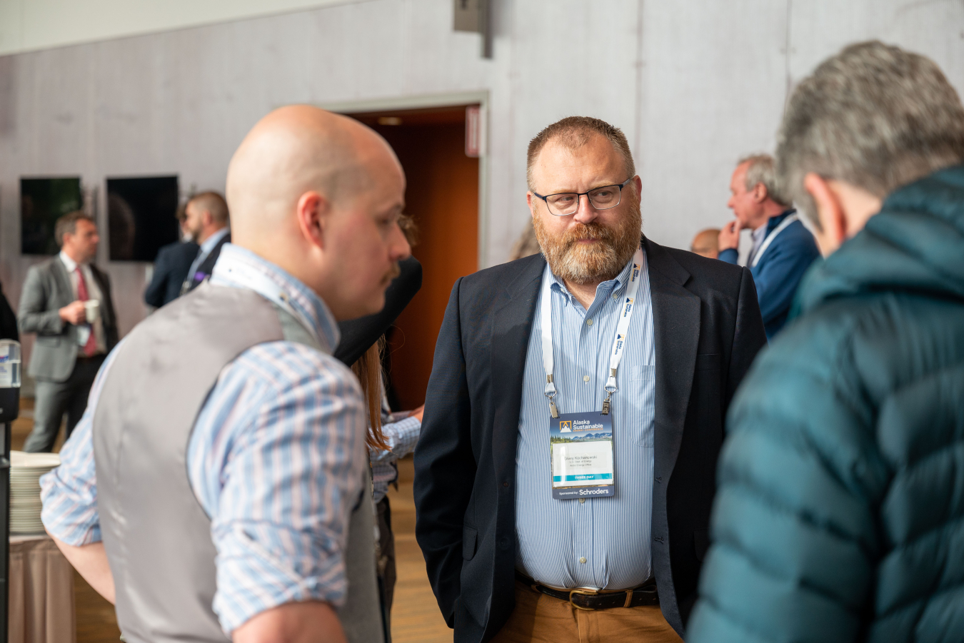 Arctic Energy's Senior Advisor on Alaska, Givey Kochanowski (center), in conversation with attendees at the Alaska Sustainable Energy Conference.