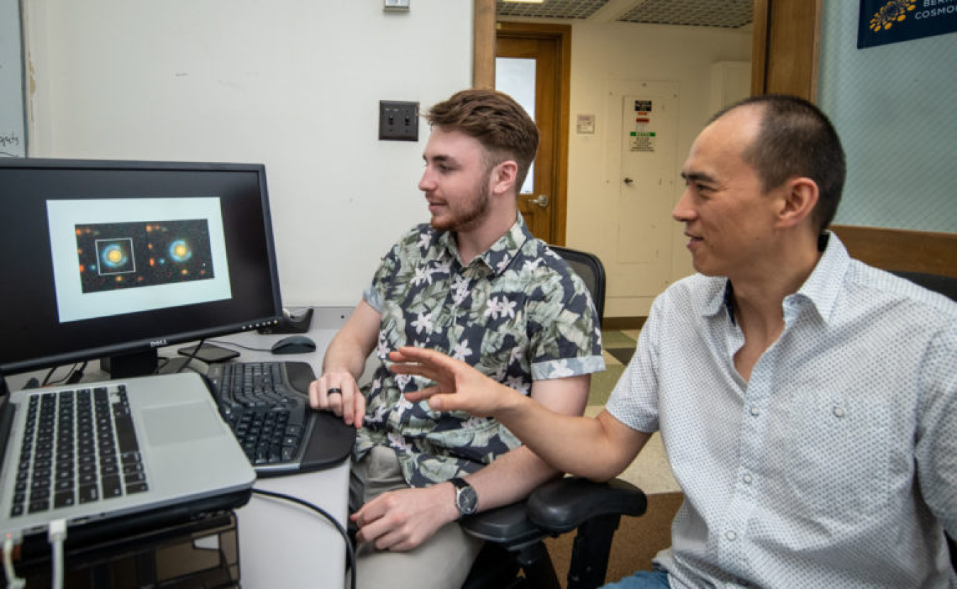 Christopher Storfer examining data with his mentor