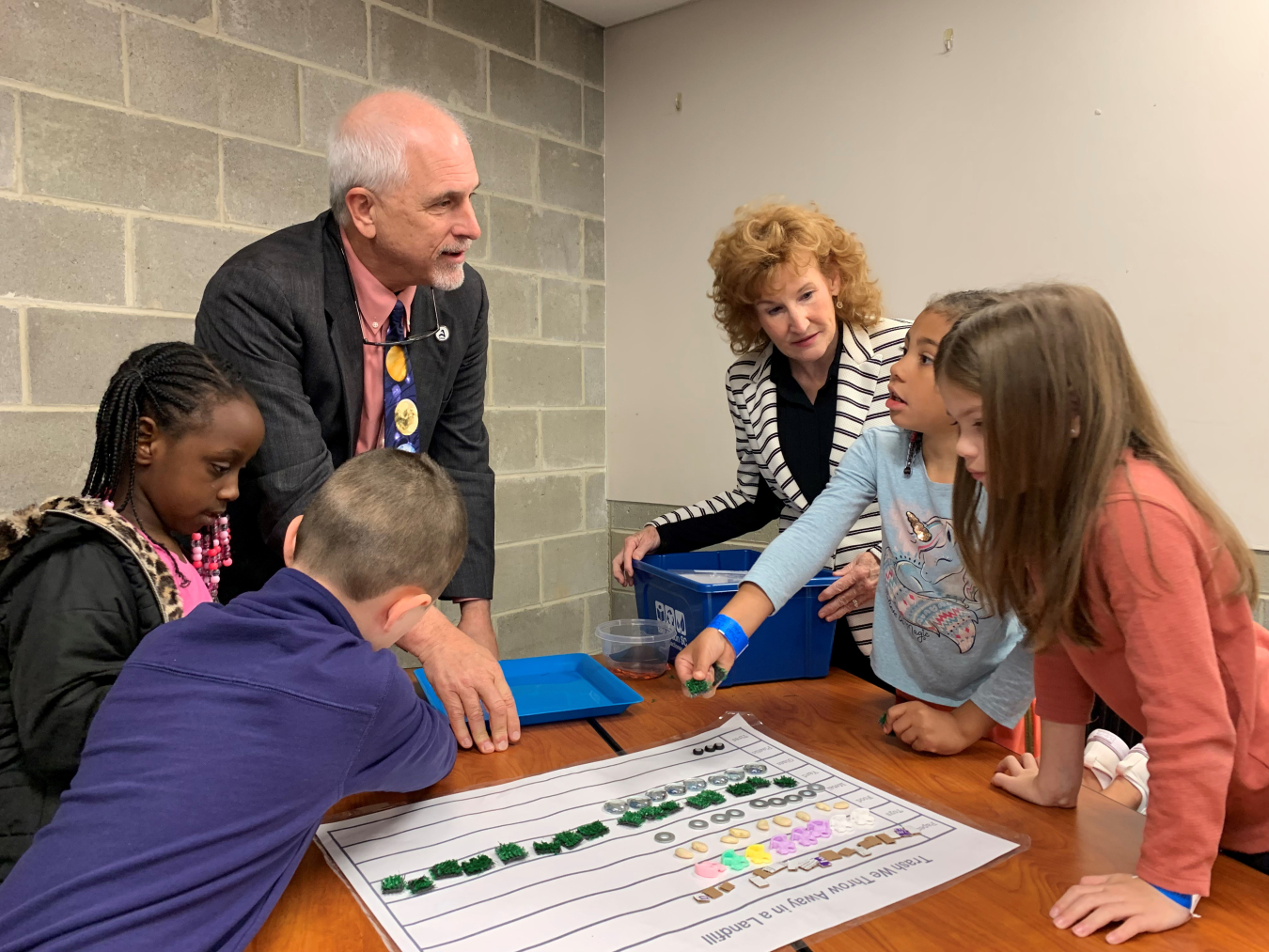 Gary Senn, director of the Ruth Patrick Science Education Center, and Kim Mitchell, education outreach lead with Savannah River Nuclear Solutions, assist second graders from Chukker Creek Elementary School in Aiken with a project.