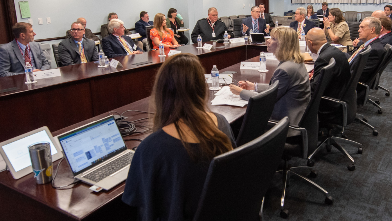 Participants in a recent meeting discuss efforts to collaborate in science and technology fields to enhance national security.