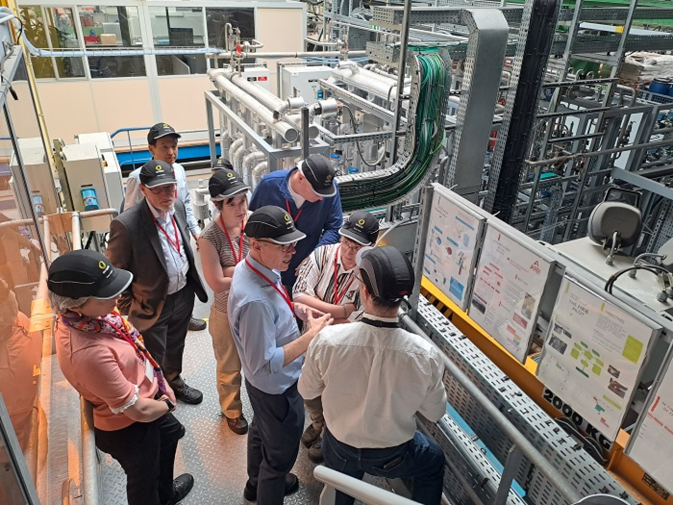 EM Senior Advisor William “Ike” White is pictured at center discussing the Cold Crucible Melter in operation at the Research Hall of Beaumont-Hague.