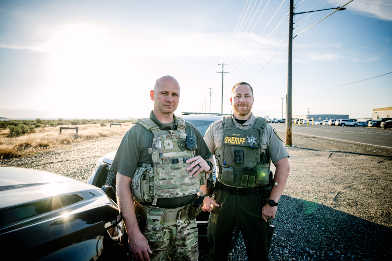 Working together to keep Hanford Site roads safe, Hanford Patrol Deputy Chief Jason Gessner, left, and Benton County Sheriff’s Deputy Grant Larson are committed to promoting traffic safety as part of a partnership established by EM Richland Operations Office contractor Hanford Mission Integration Solutions.