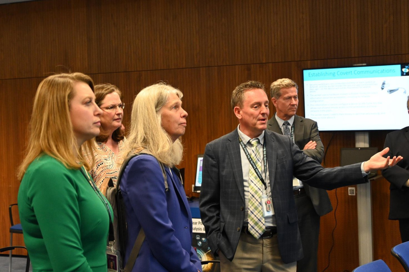 NNSA Deputy Administrator Corey Hinderstein, left, and Administrator Jill Hruby listen to a cybersecurity presentation.