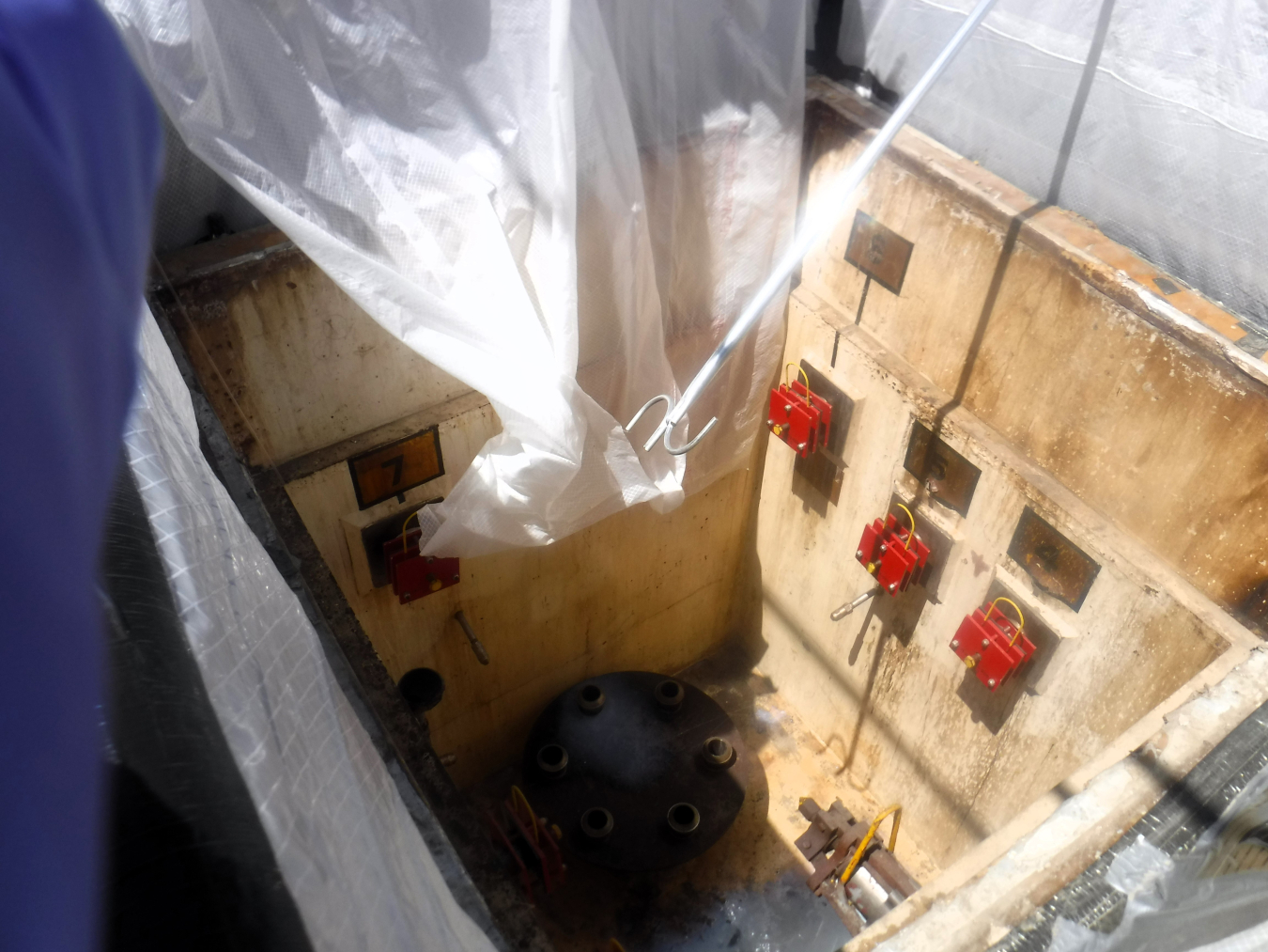 Workers used long-reach tools to clean out an enclosure above Tank A-102 so that pipefitters could remove the welding and break the equipment free. This is pictured in February 2022 on the Hanford Site.