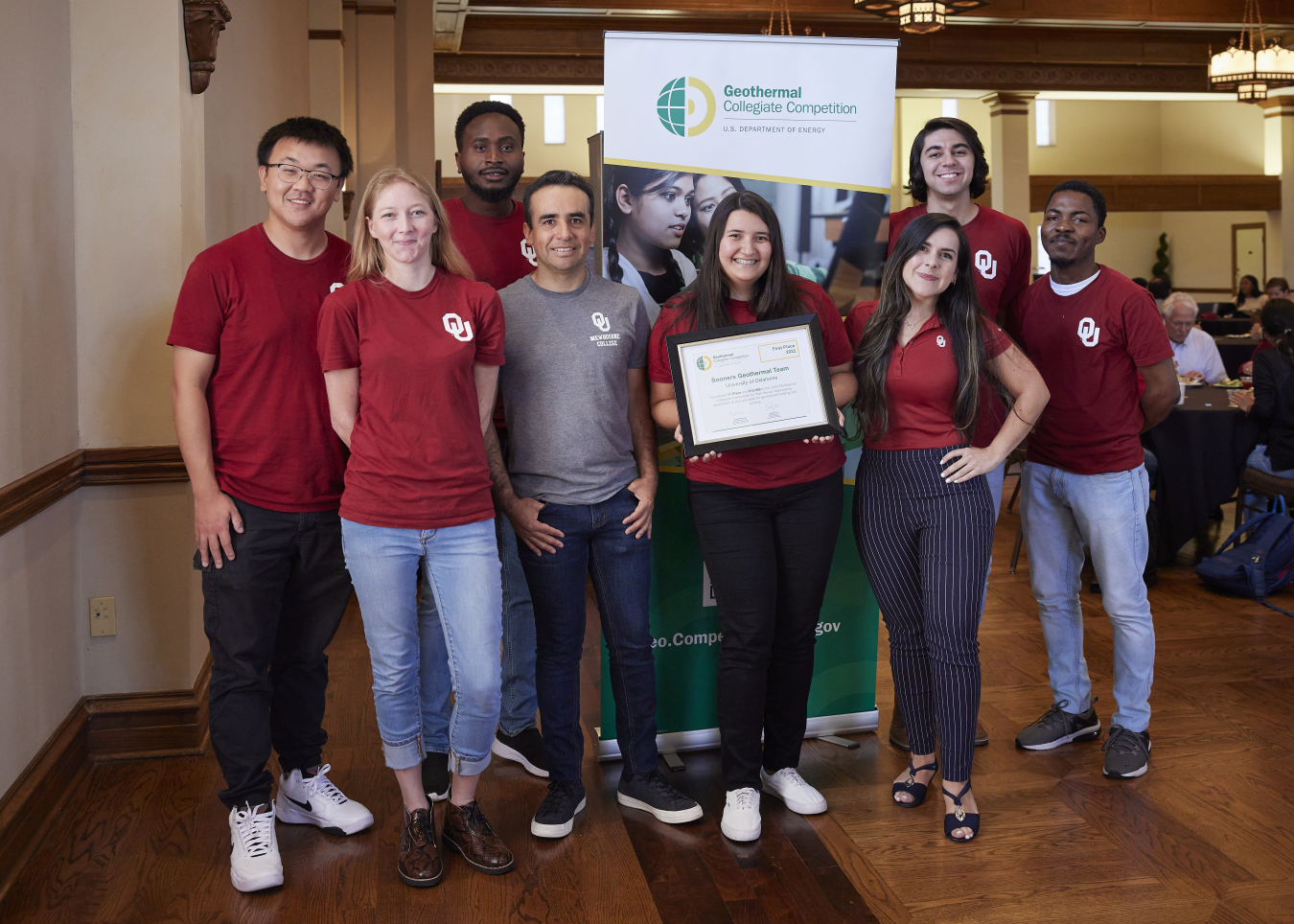 The 2022 Geothermal Collegiate Competition winning team from the University of Oklahoma poses for photo in front of competition banner