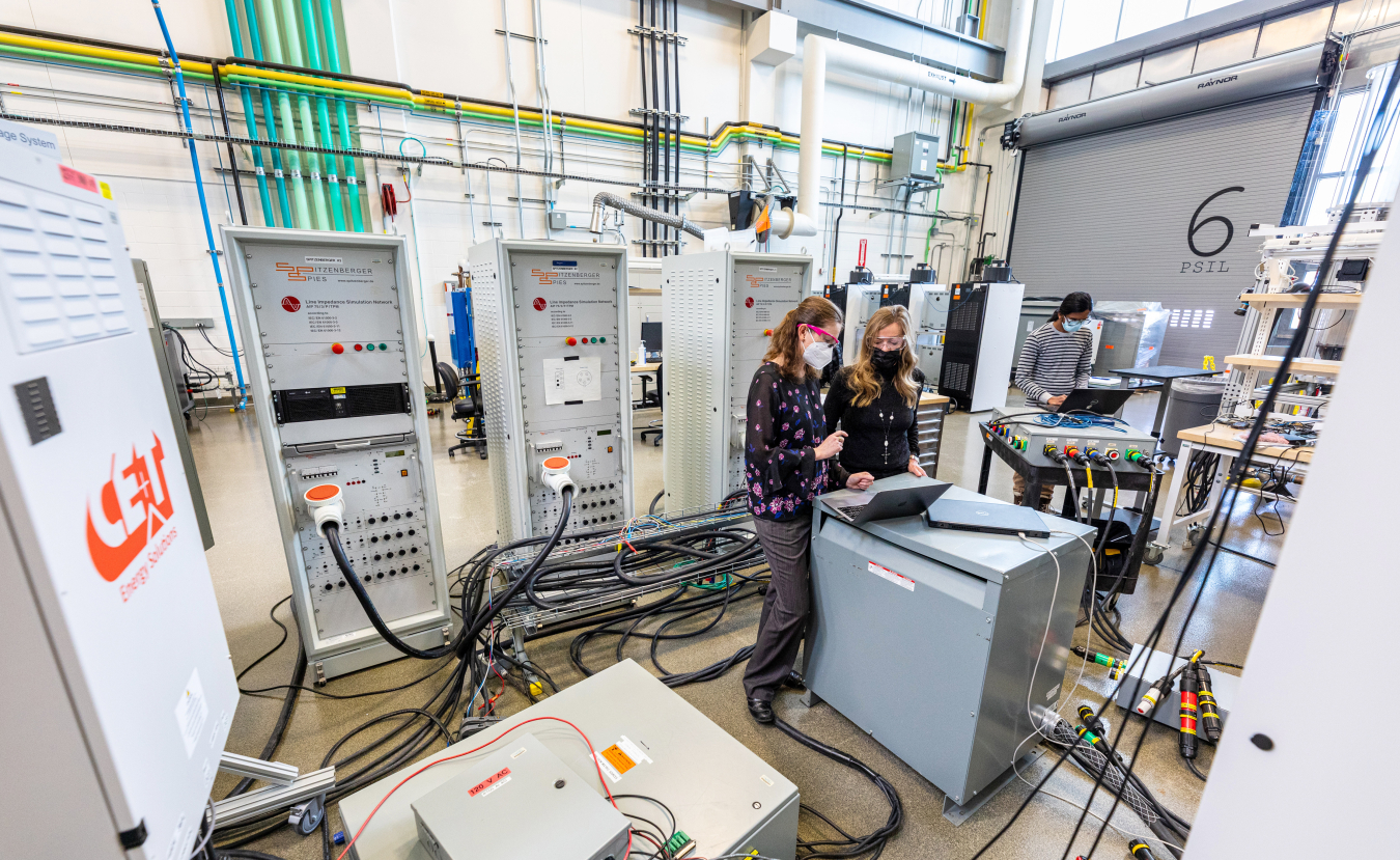 Researchers surrounded by equipment in a laboratory. 