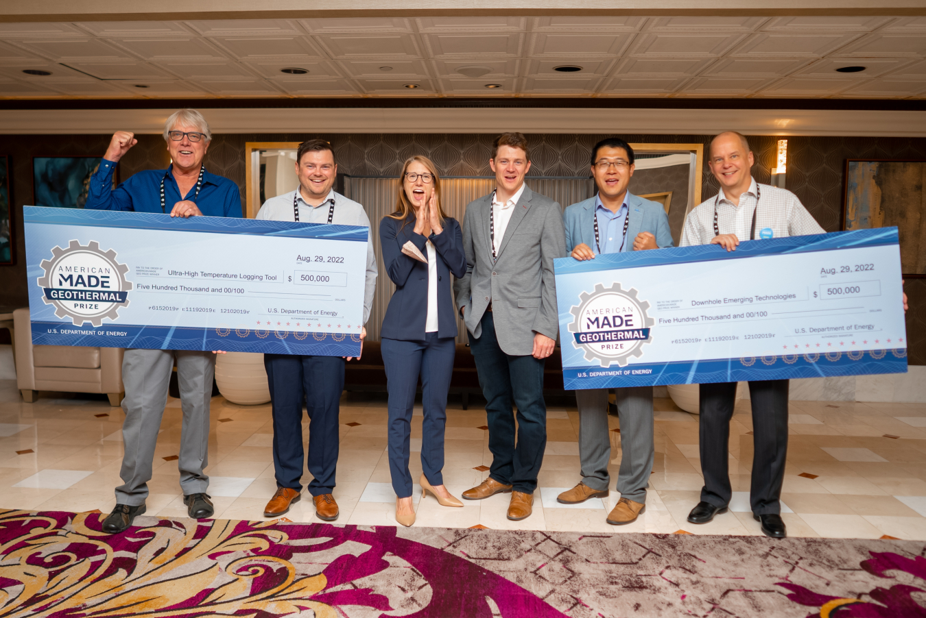 Geothermal Manufacturing Prize Winners hold up their giant checks with GTO staff members