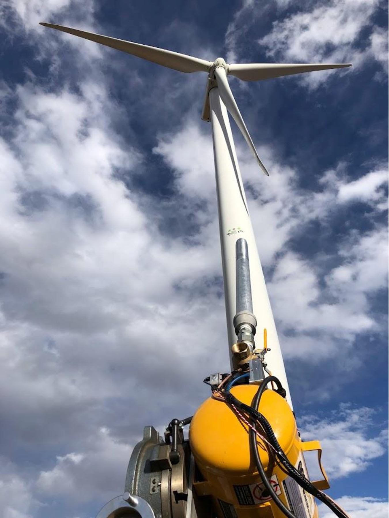 Worker in front of a wind turbine. 