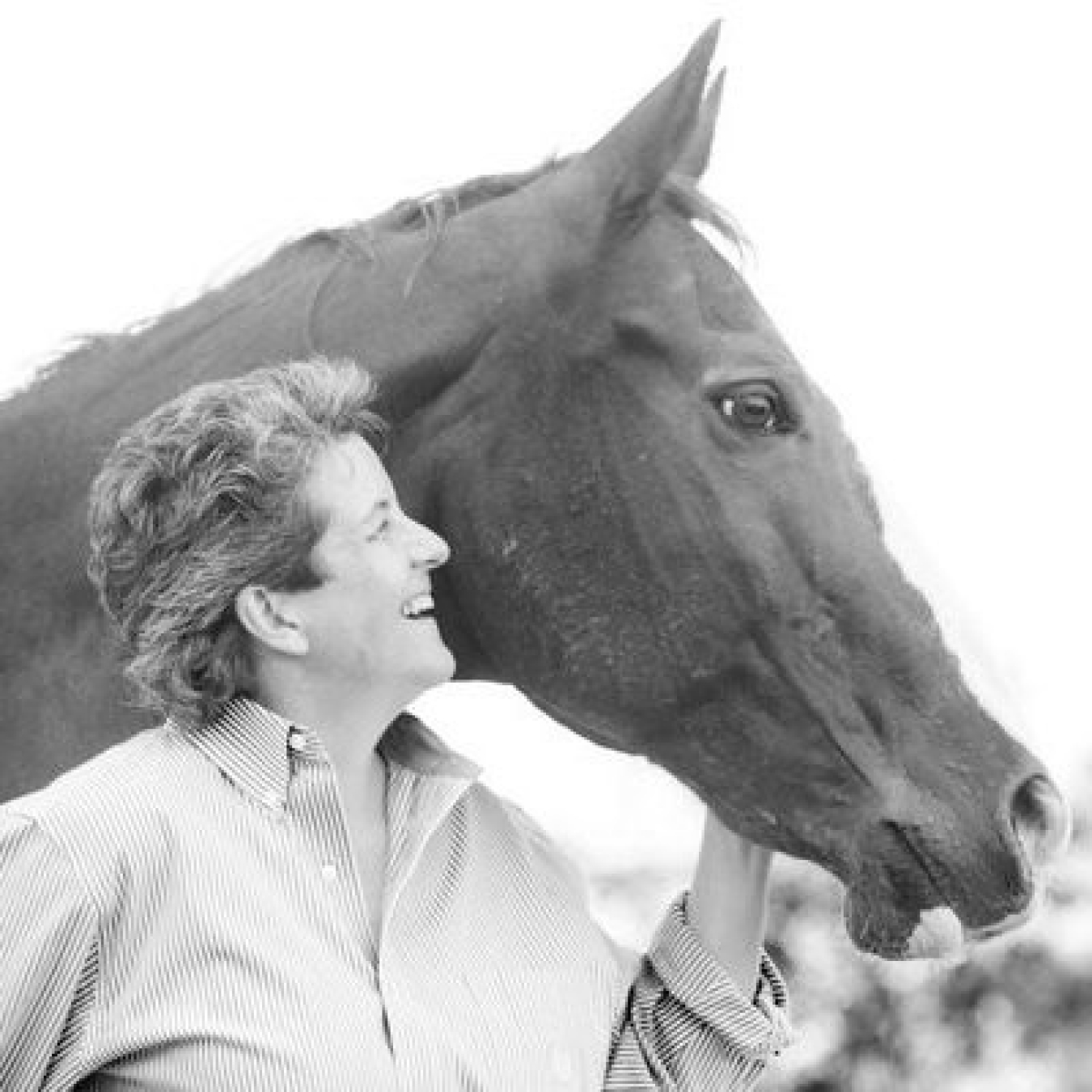 Kathy looking at a horse in black and white