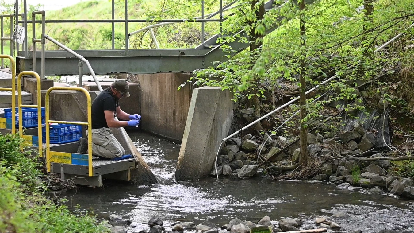 A still shot featured in EM’s new groundwater cleanup video shows a Paducah Site worker performing environmental water sampling activities.