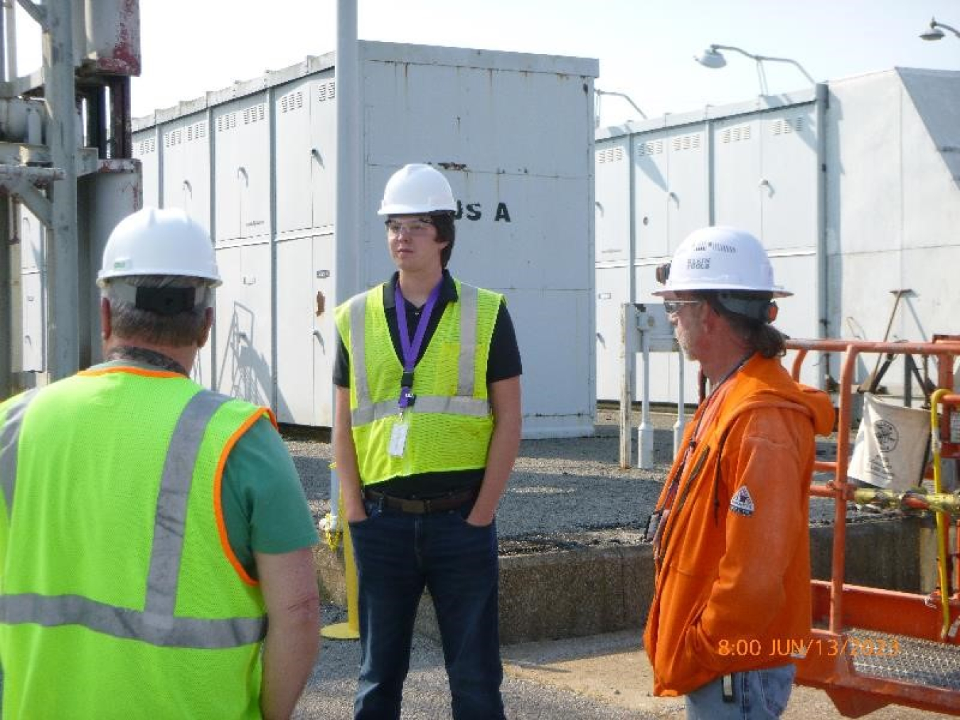 Enterprise Technical Assistance Services Summer Intern Colton May, center, speaks with Paducah Site workers on the C-535 Switchyard Demolition Project.