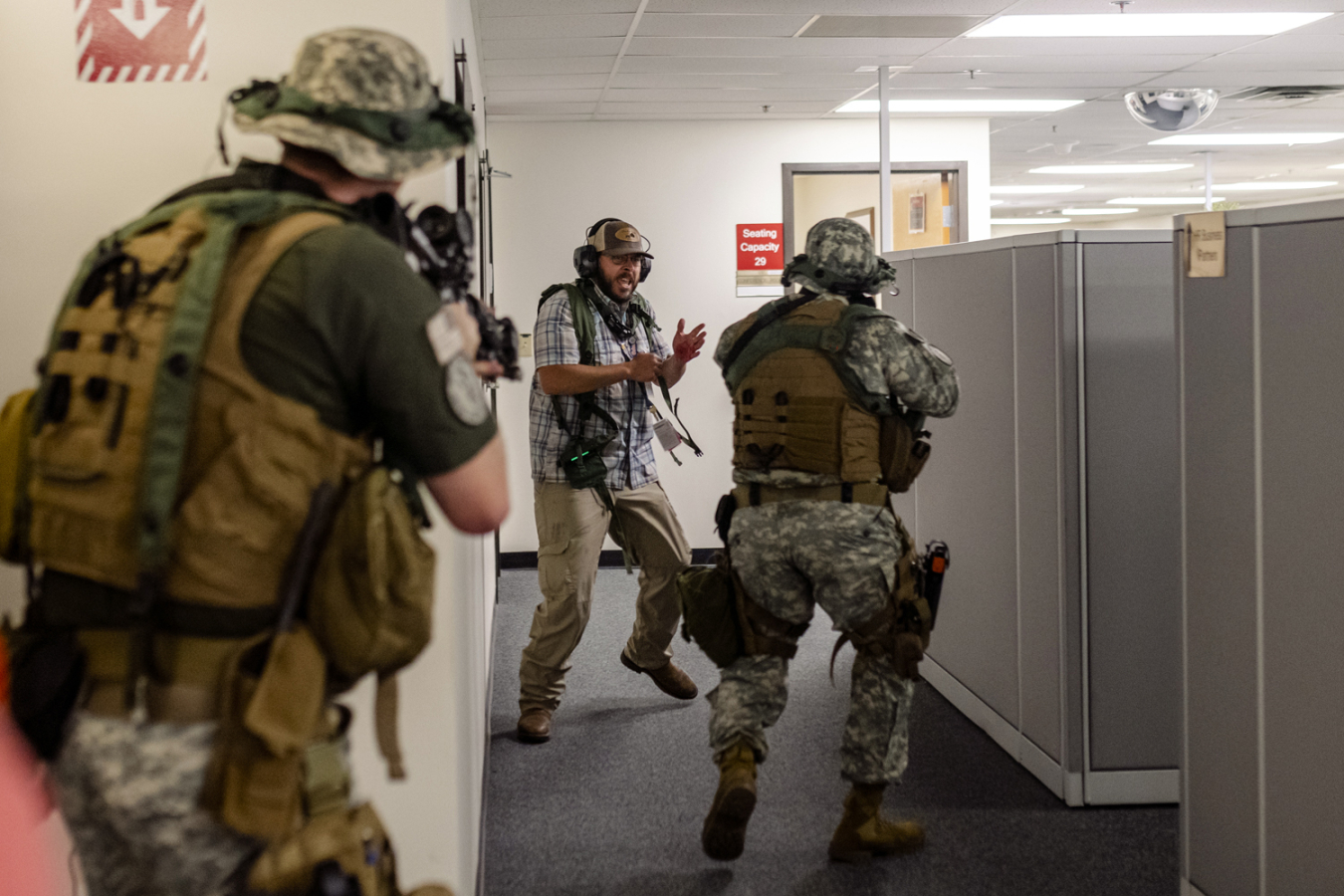 A role-playing employee pretends to be surprised by Savannah River Site security personnel as he flees from a building where an active shooter exercise was conducted. More than 300 site personnel participated in the training.