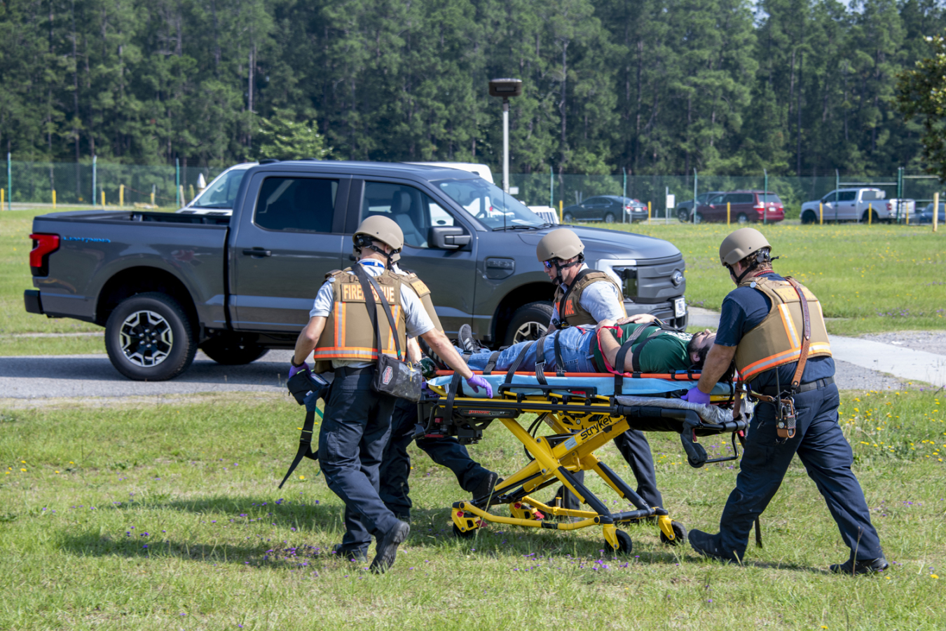 Savannah River Site (SRS) Fire Department personnel carefully rush an SRS employee, who acted as if wounded during an emergency response exercise, to a waiting ambulance. The event helped members of the rescue team further improve their skills, knowledge and experience during the training.