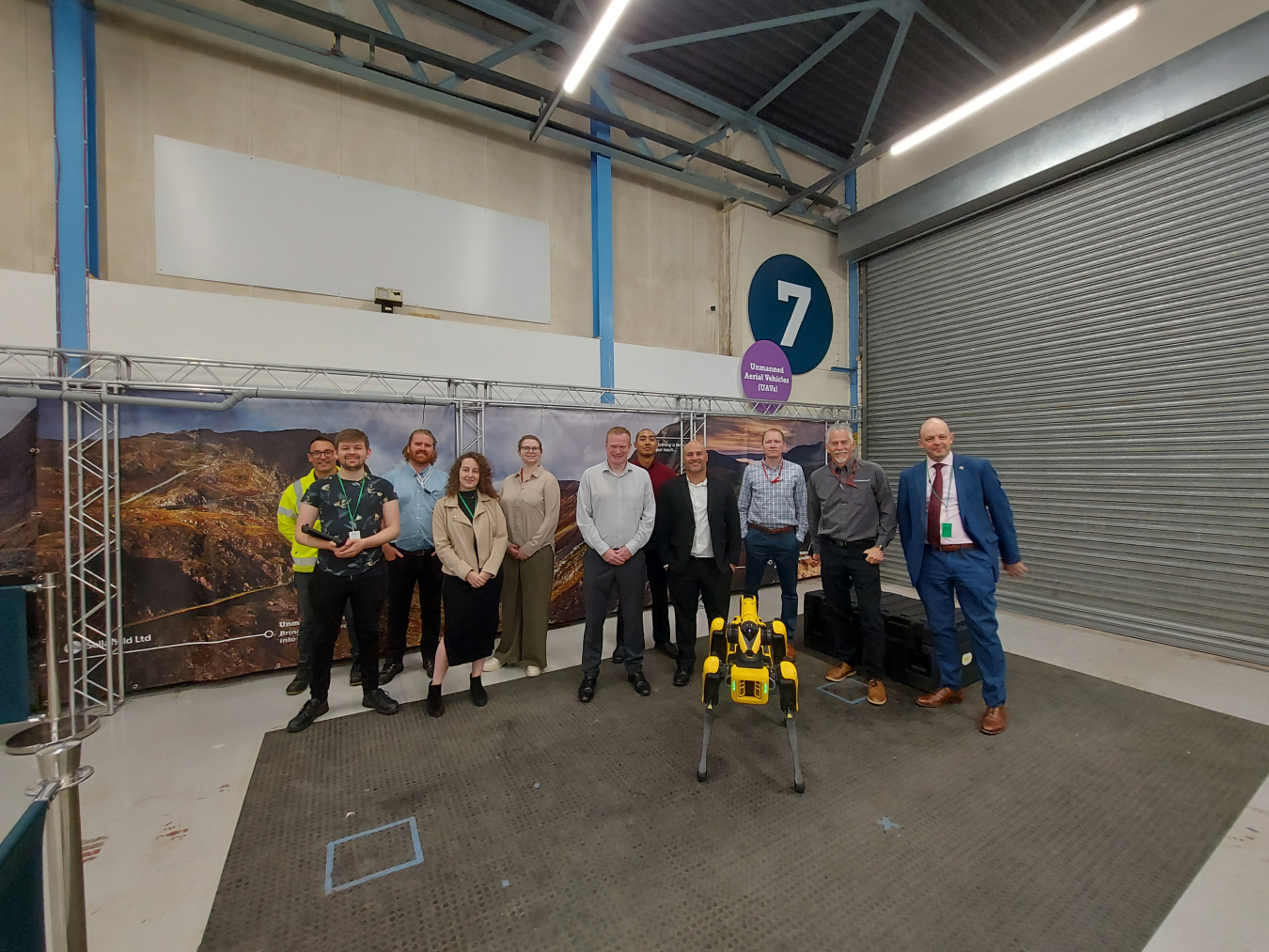 A team from EM and Sandia National Laboratories is pictured observing a demonstration of the Spot Robot at the Sellafield Engineering and Maintenance Centre of Excellence with Sellafield representatives. From left are Niall Paterson, Joshua Hudson, Luke Henley and Alice Nash, Sellafield; Ashley Furman, Longenecker and Associates; a Sellafield representative; Michal Rittikaidachar, Sandia; Jean P. Pabón, EM Technology Development Office; Jason Wheeler and Jake Deuel, Sandia; and Ed Matthews, Sellafield.