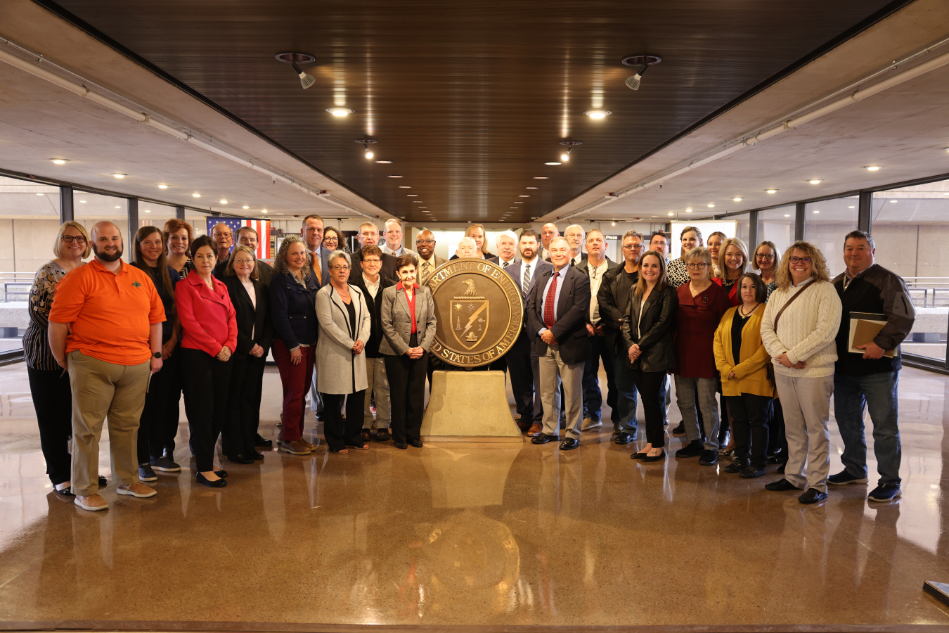 Members of the Environmental Management Site-Specific Advisory Board (EM SSAB), federal staff, and contractors pose in the James V. Forrestal Building during the Spring 2023 EM SSAB Chairs Meeting in Washington, DC