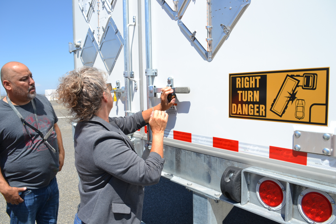 Juan Guajardo, left, and Lezlie Arntz with Hanford Site contractor Hanford Mission Integration Solutions and subcontractor North Wind apply a special lock to a truck holding Hanford classified records, accessible only by the U.S. National Archives and Records Administration upon arrival.