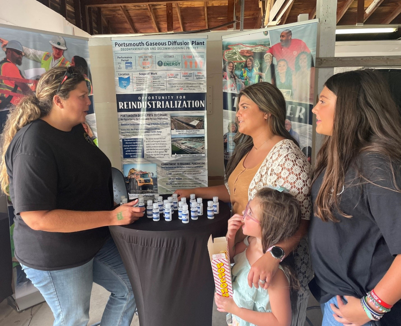 Portsmouth Site employee Kristen Martin, left, speaks with fairgoers at the Scioto County Fair about project progress and Fluor-BWXT-Portsmouth’s involvement in community activities.