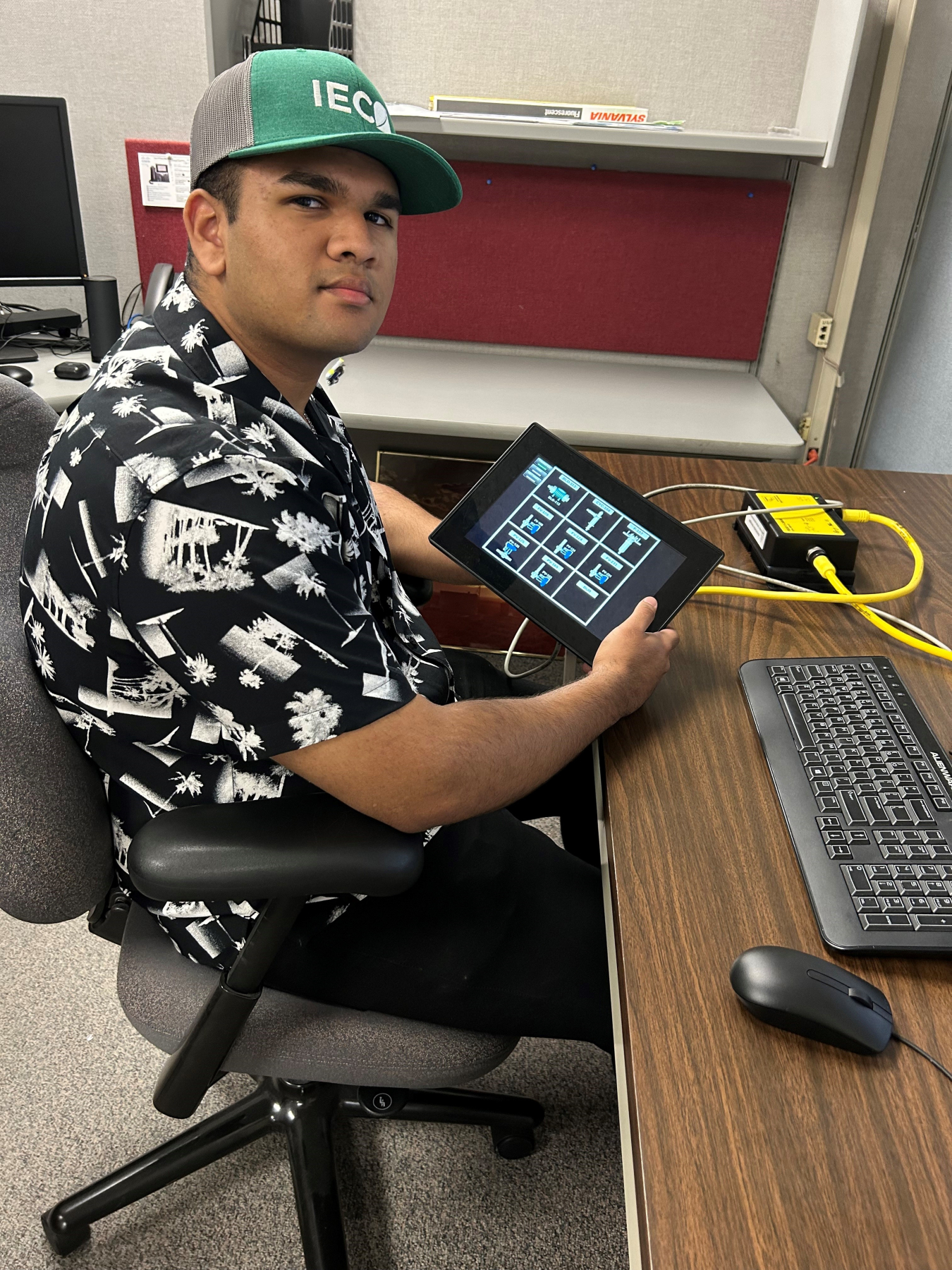 Idaho Environmental Coalition intern Rajit Nilkar shows the human-machine interface controls he developed for EM’s Calcine Retrieval Project.