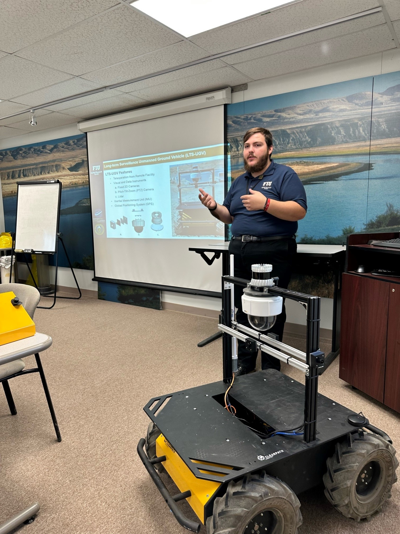 DOE Fellow Brendon Cintas presents a robot he modified to better serve EM’s mission at the Hanford Site after adding multiple cameras, data-collection technology and remote-control capability, during a recent demonstration at Hanford.