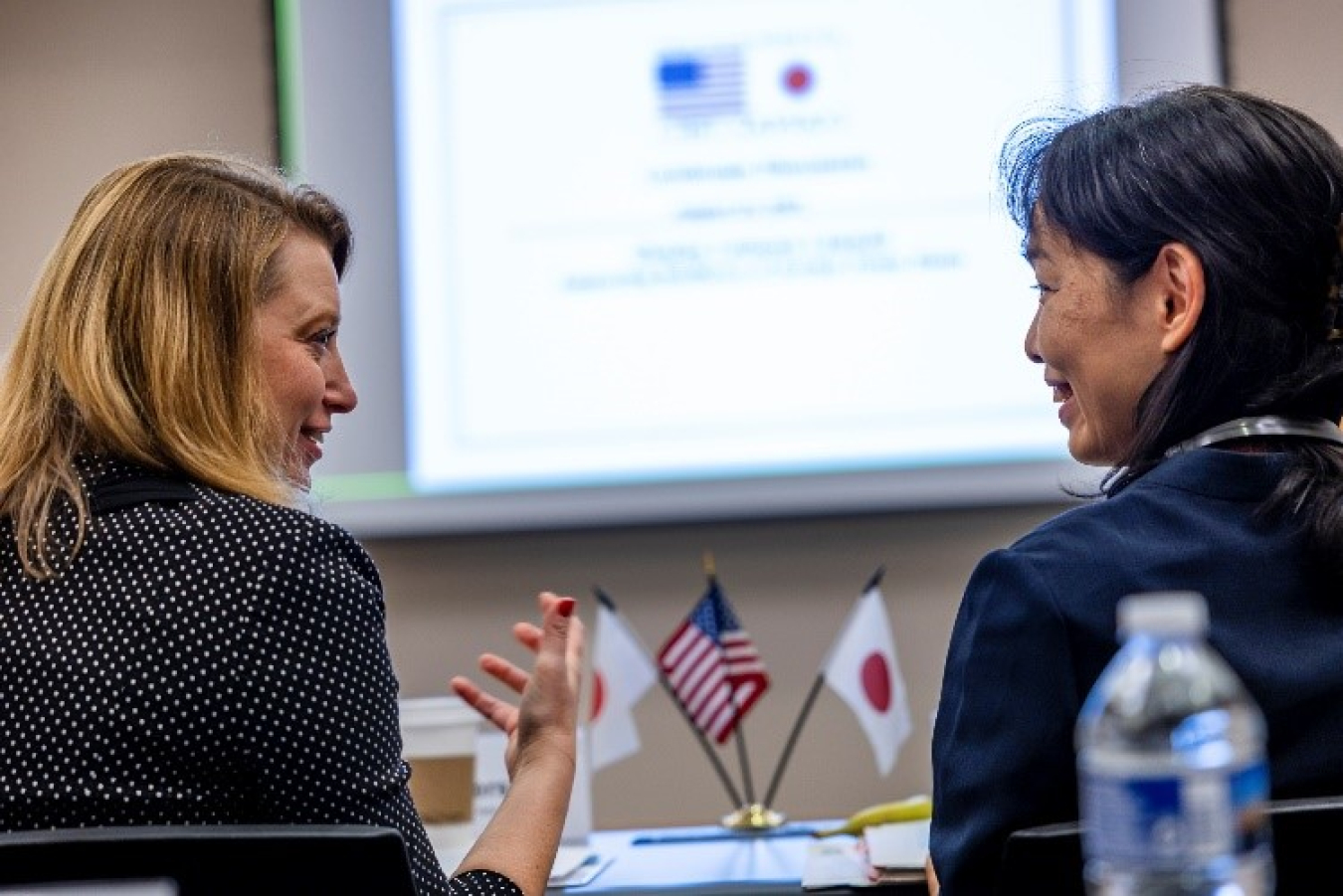 Corey Hinderstein and Ambassador Mitsuko Hayashi face each other.