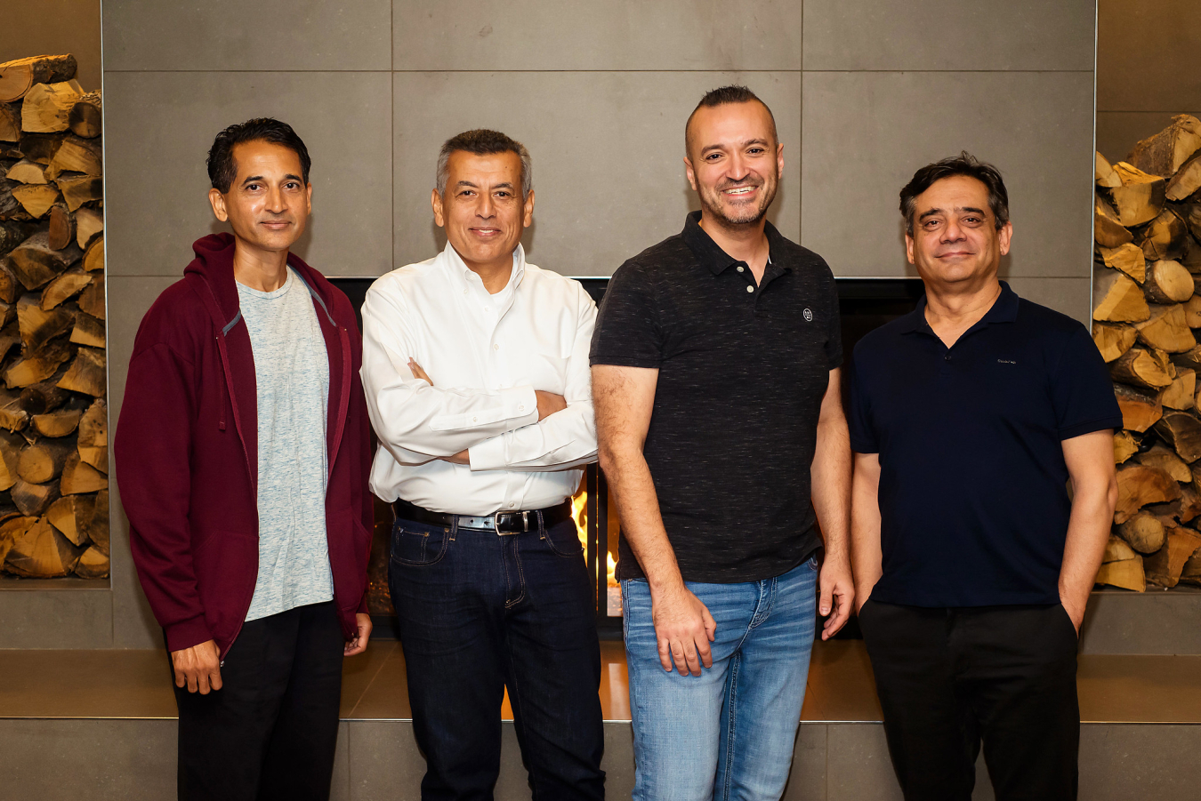 Four people pose and smile for the camera.