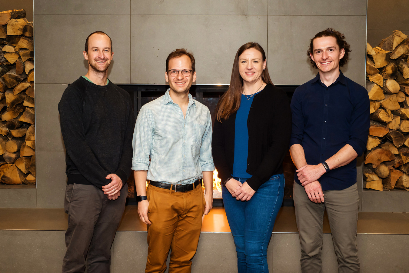 Four people pose and smile for the camera.