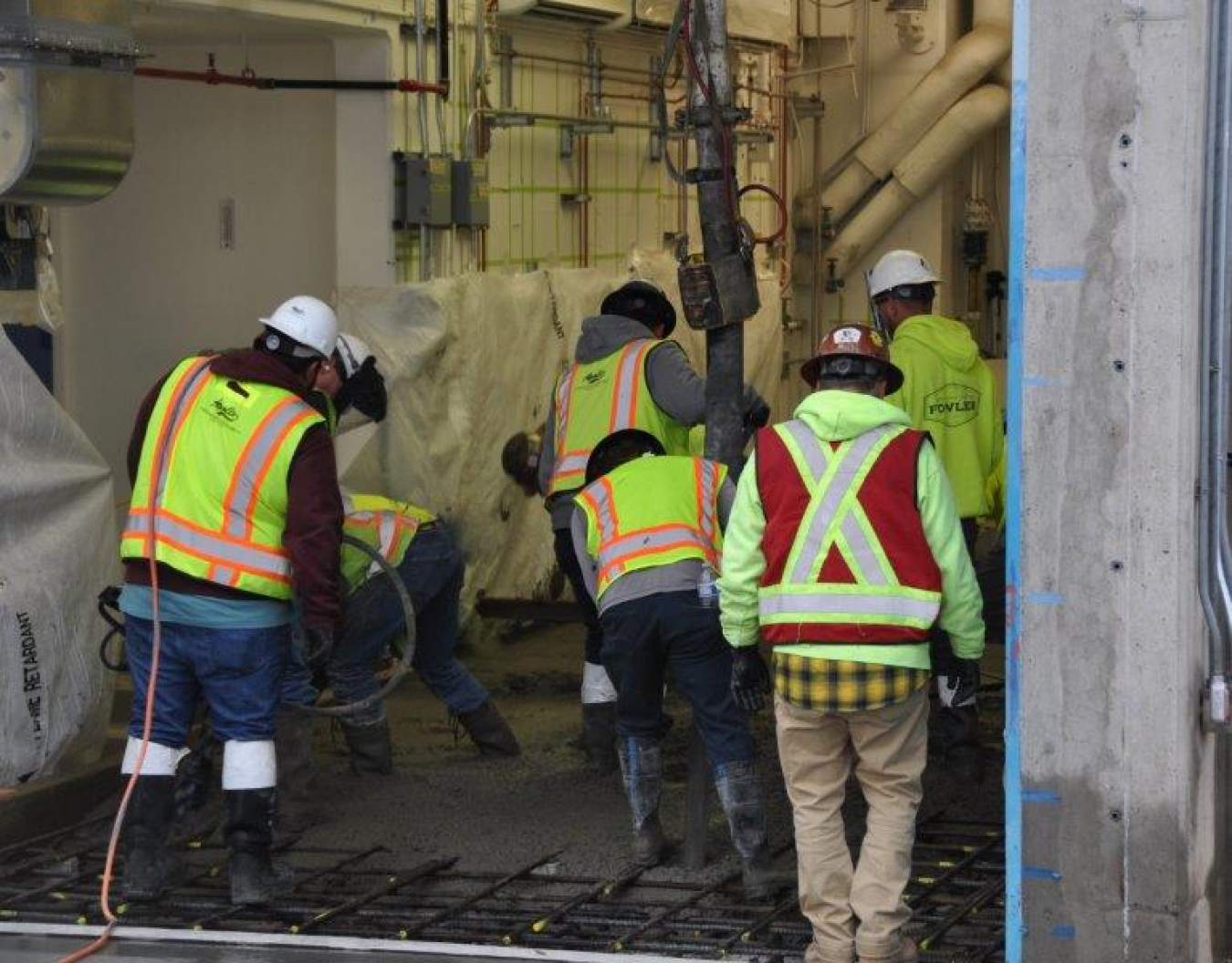 Photo of workers pouring concrete