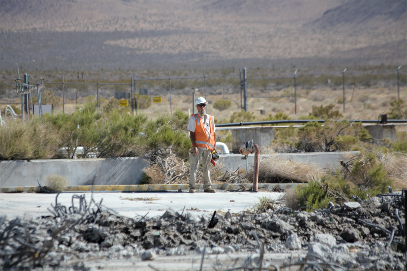 Worker standing at demolition site