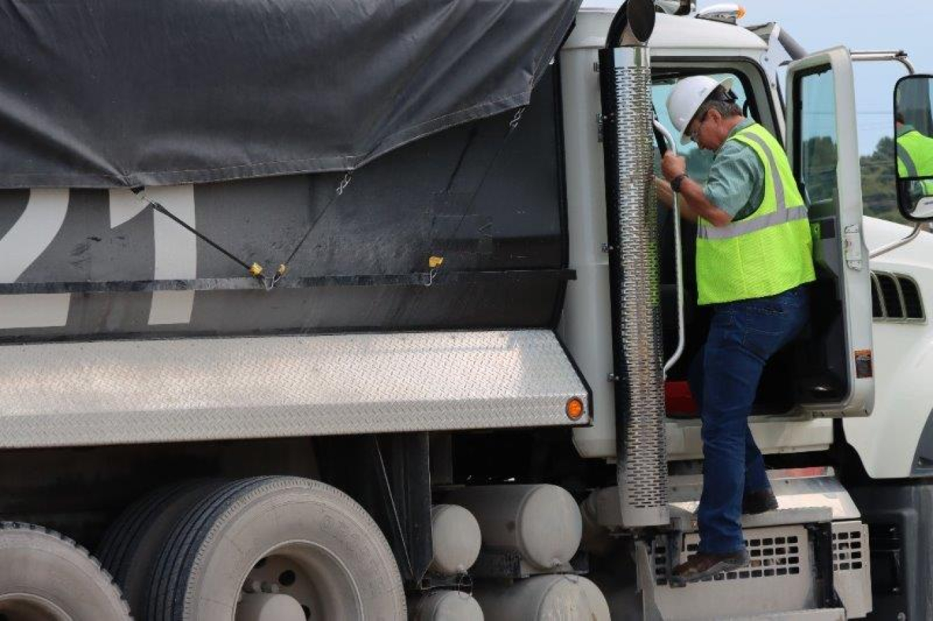 Photo of worker getting into truck