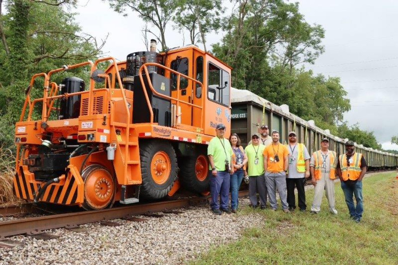 Photo of people posing with rail cars ready for shipment