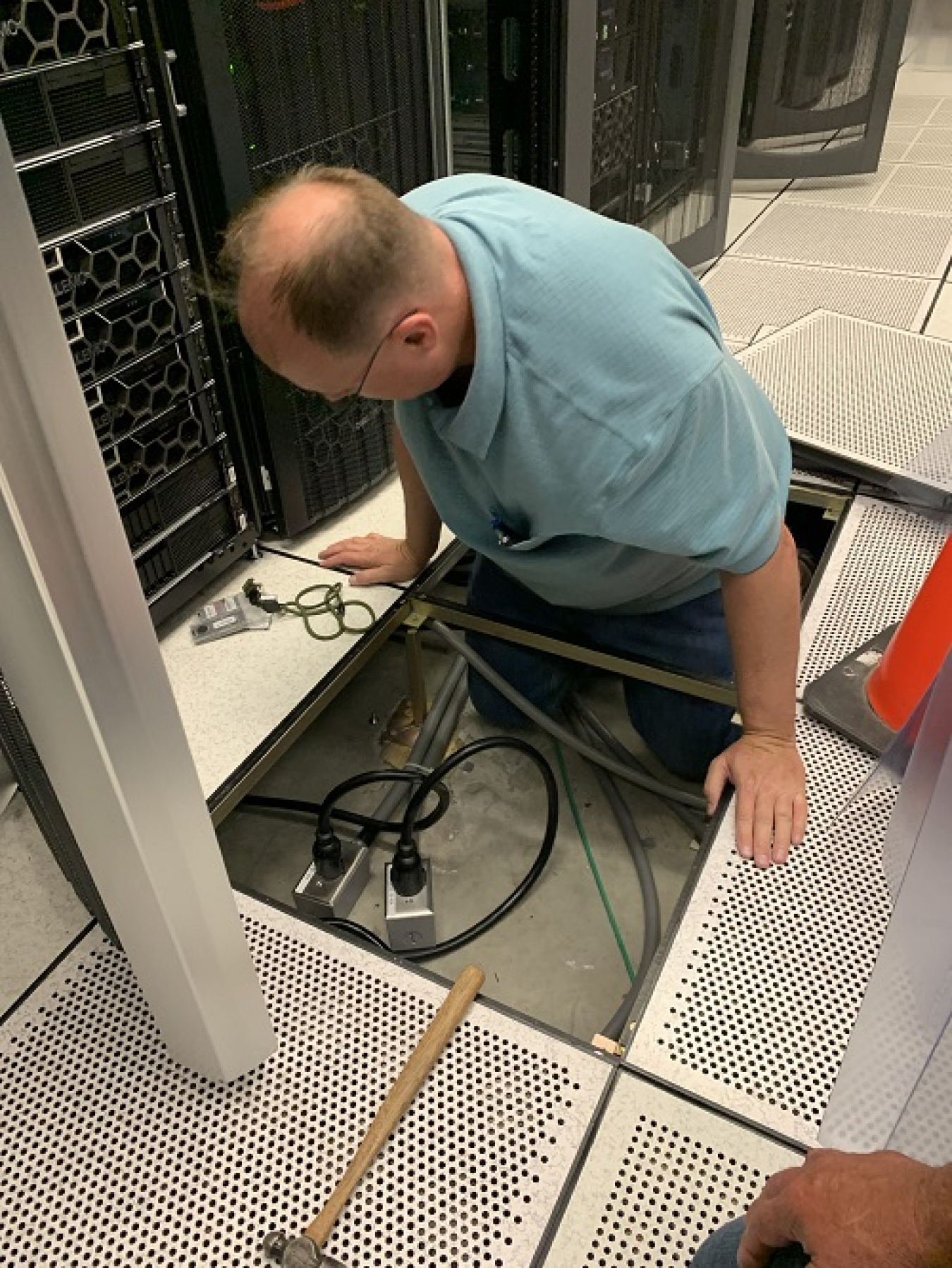 Instrument Technician working on the floor with electrical equipment.