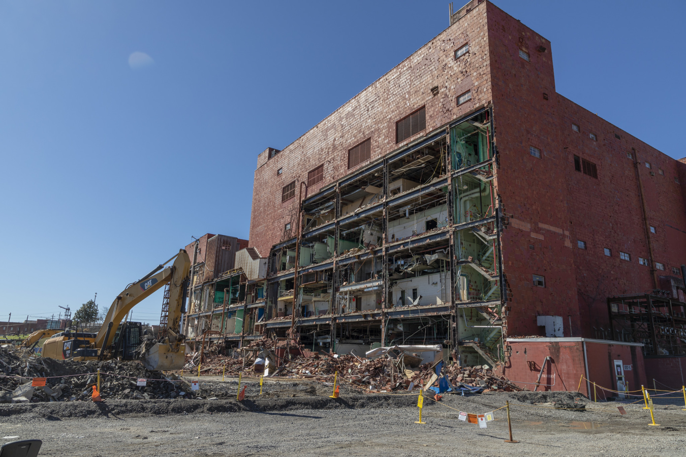 A tall brick building being demolished