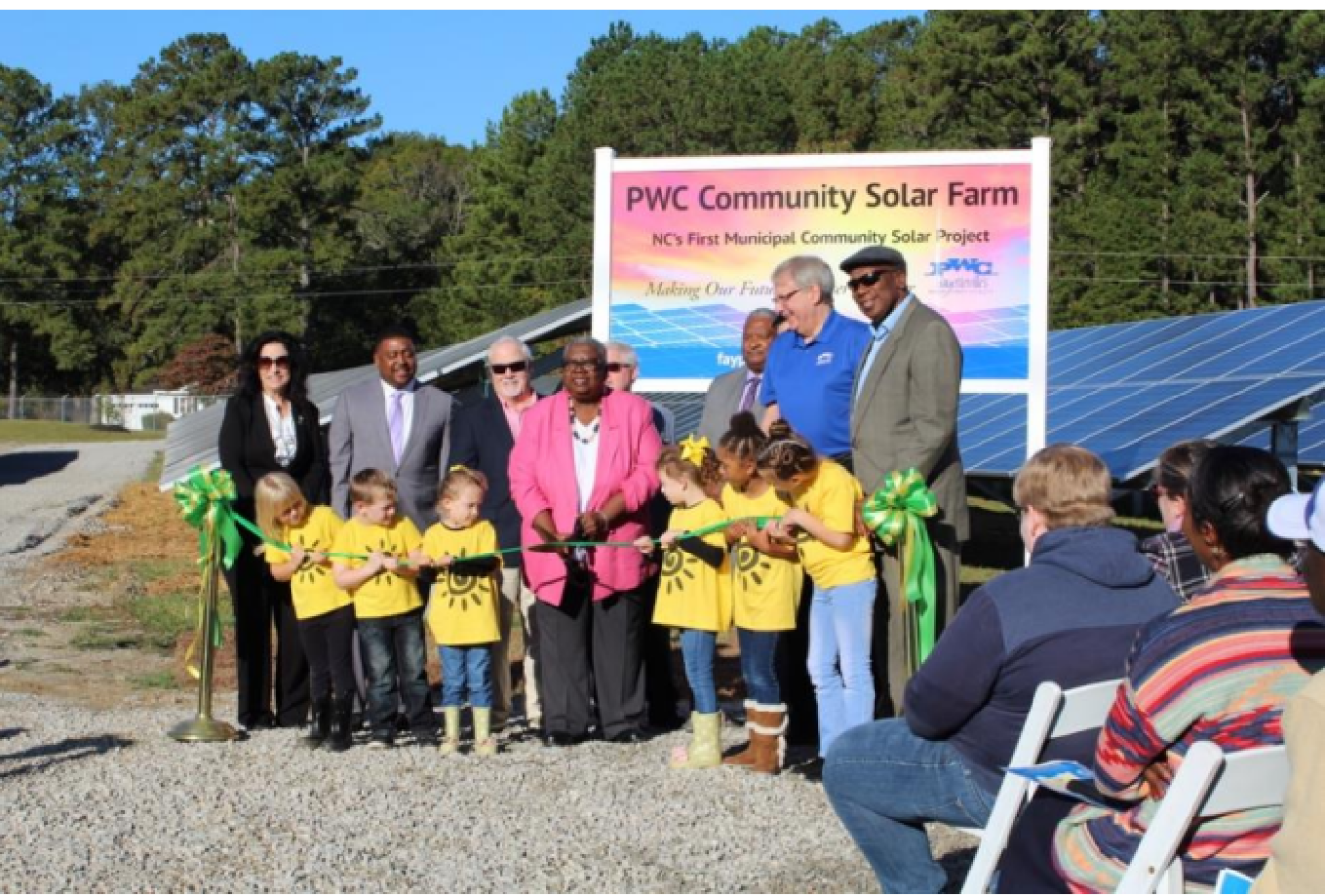 People gather at a ribbon cutting for a community solar array in Fayetteville, NC.