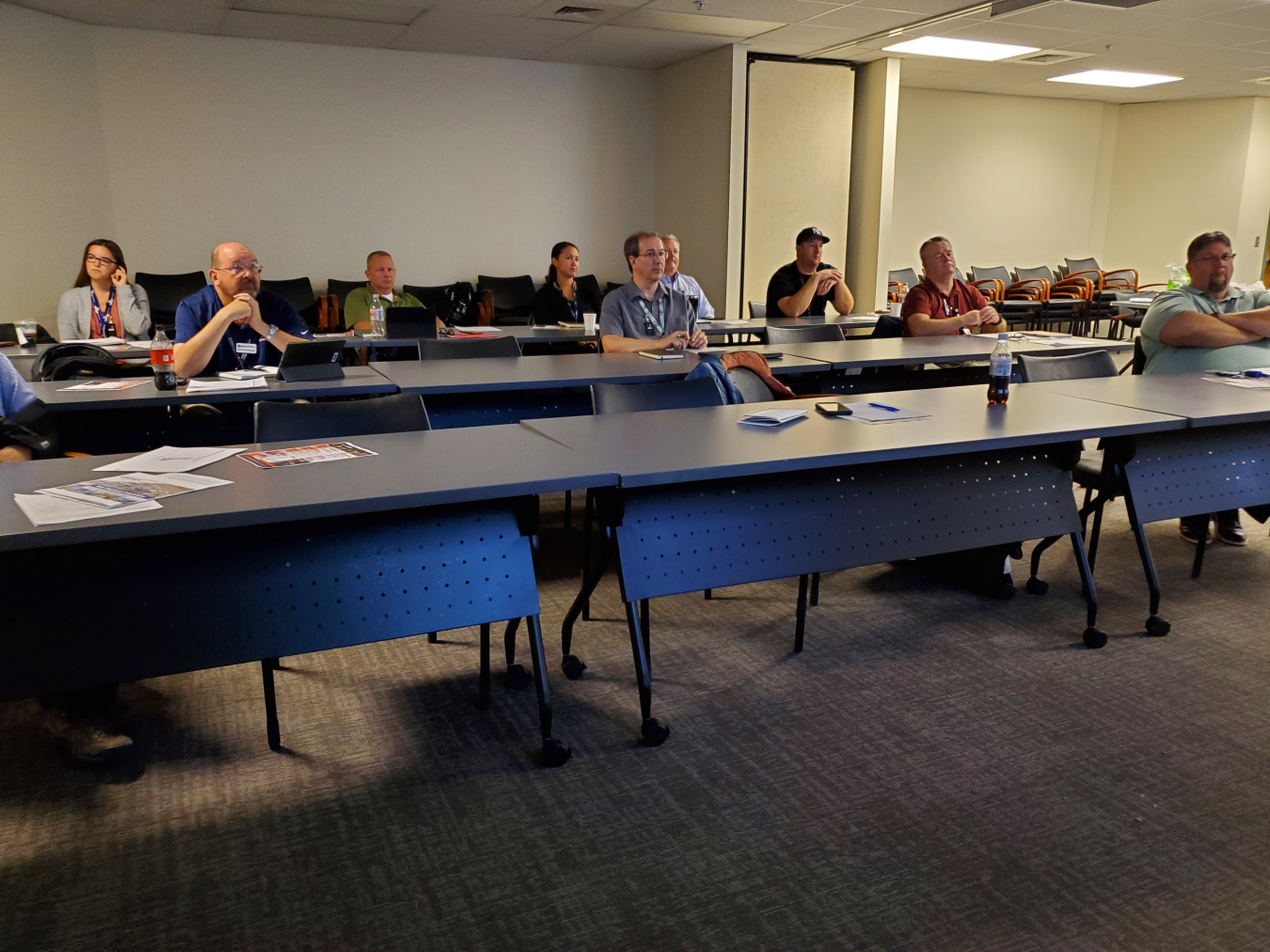 Employees with Hanford Site contractor Washington River Protection Solutions attend training seated at tables.