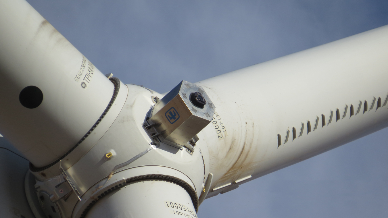 Close-up view of a spinning laser affixed to a wind turbine. 