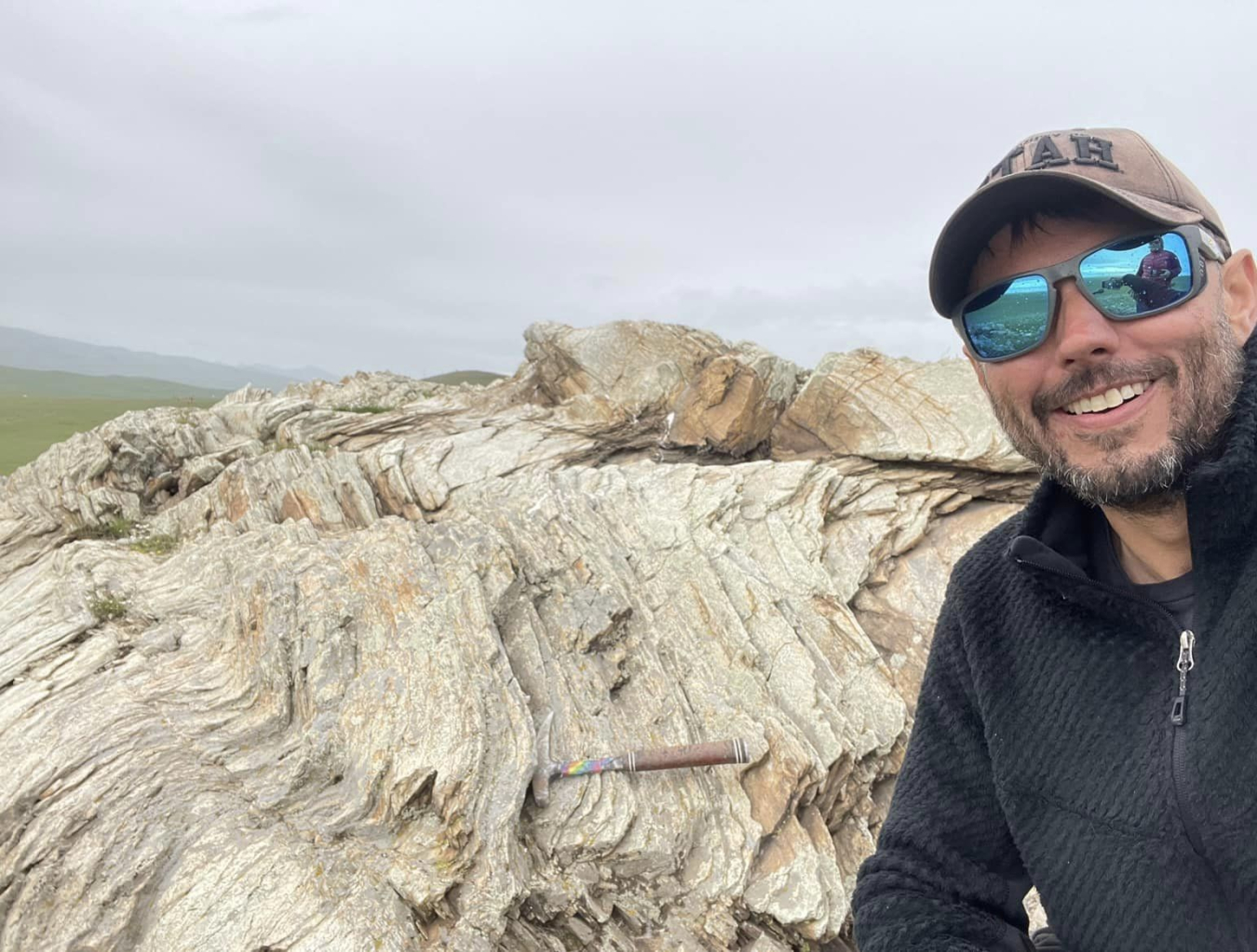 University of Utah student Justin Tully on a rocky hillside in Mongolia