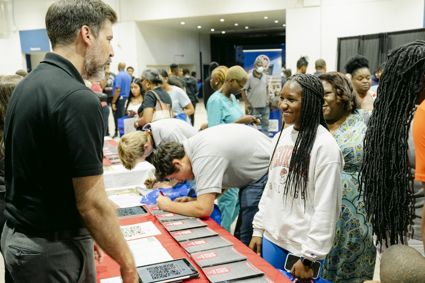 A young student talks to a man running the University of Georgia's booth