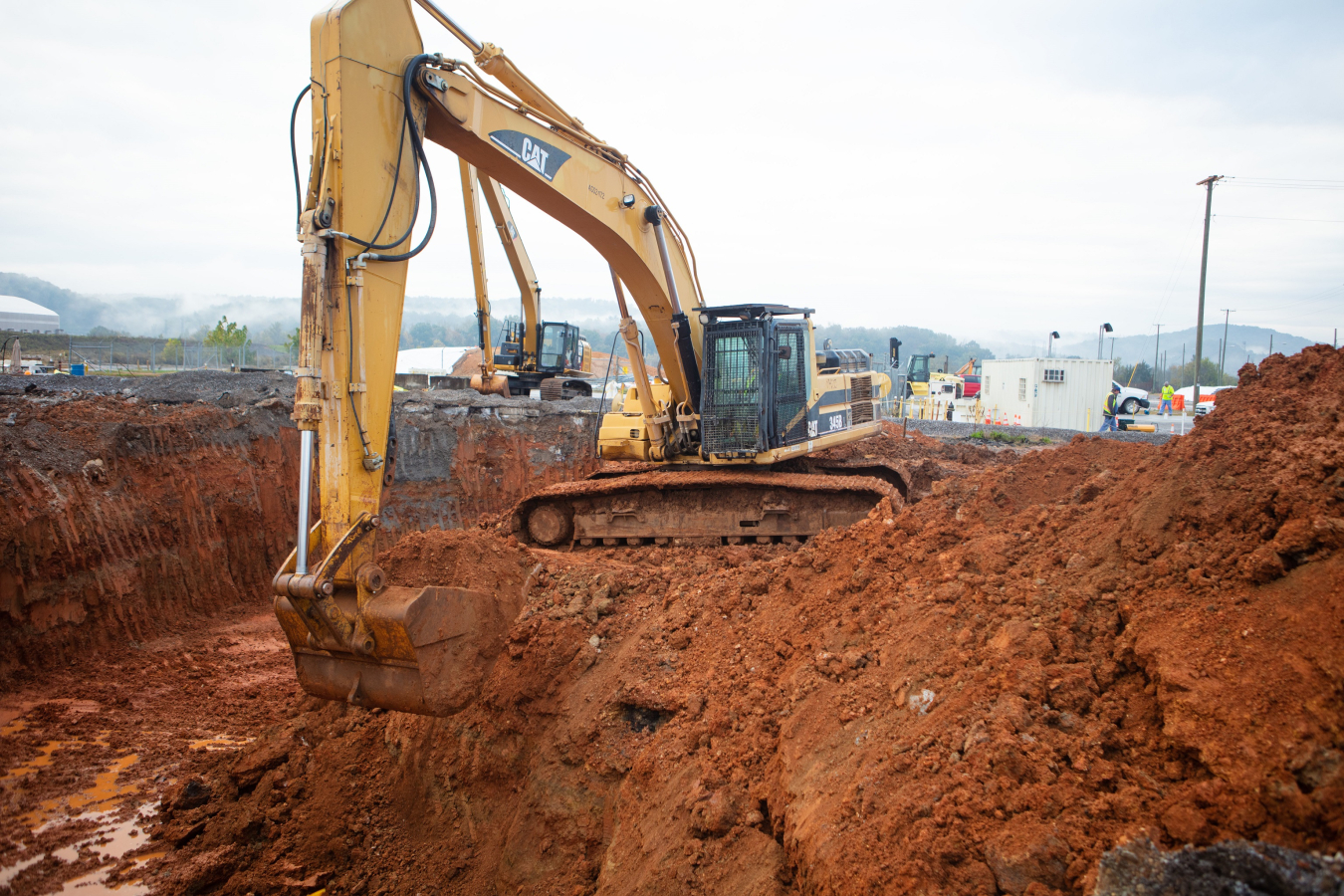 Large digger removes soil from the ground. 