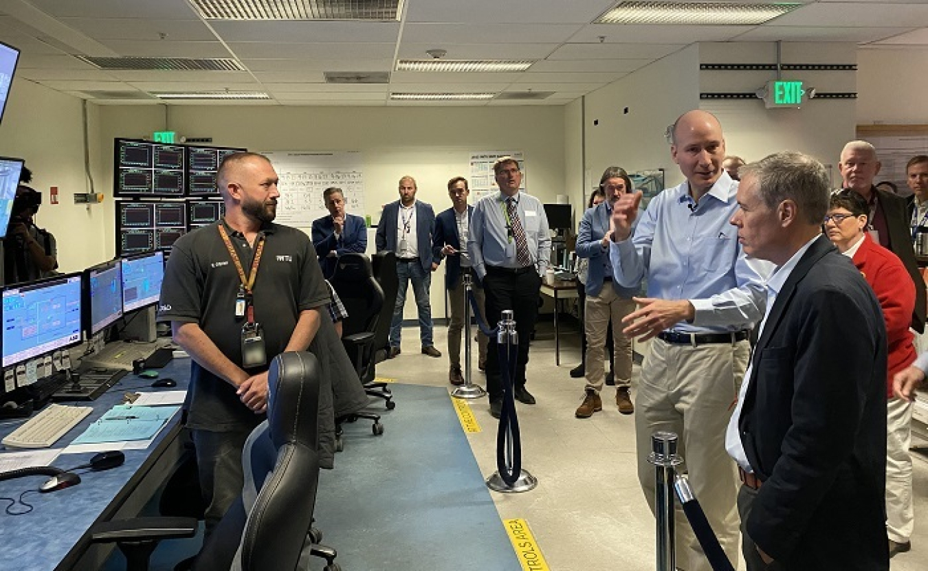 an operator welcomes people into a control room