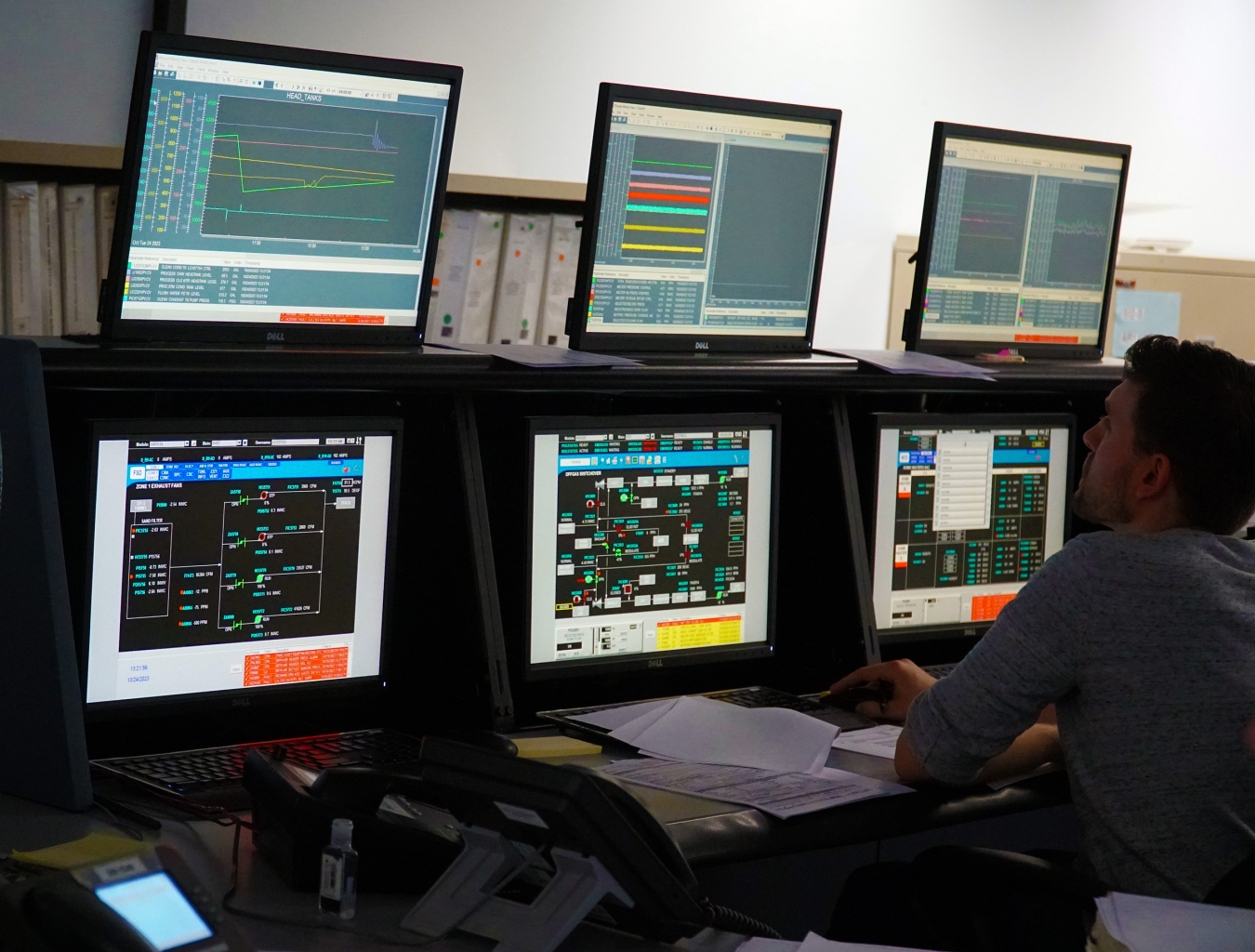 6 computer screens displayed as a part of a control room setup 