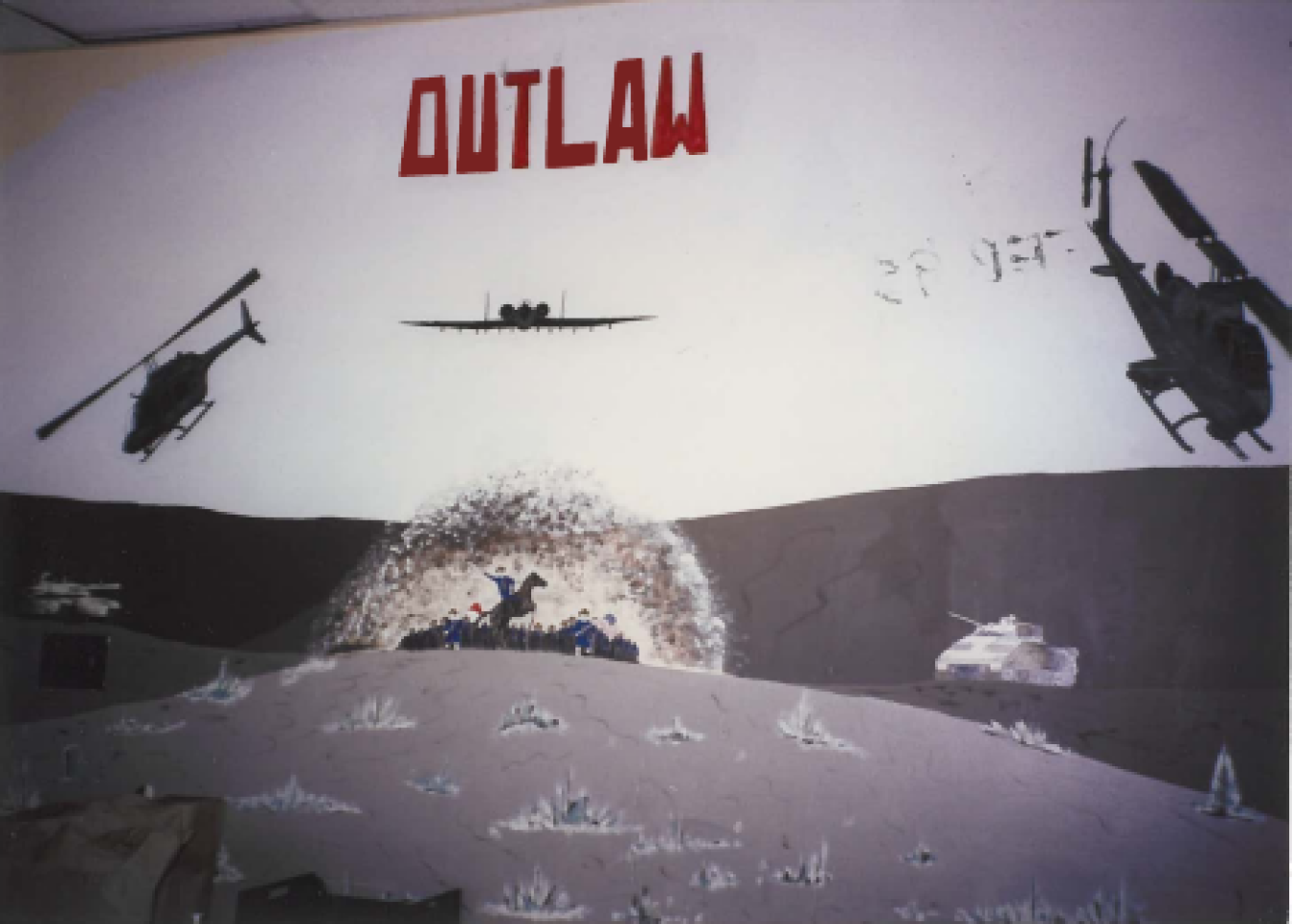 A mural painting on the wall with helicopters, an airplane, and the word "Outlaw"